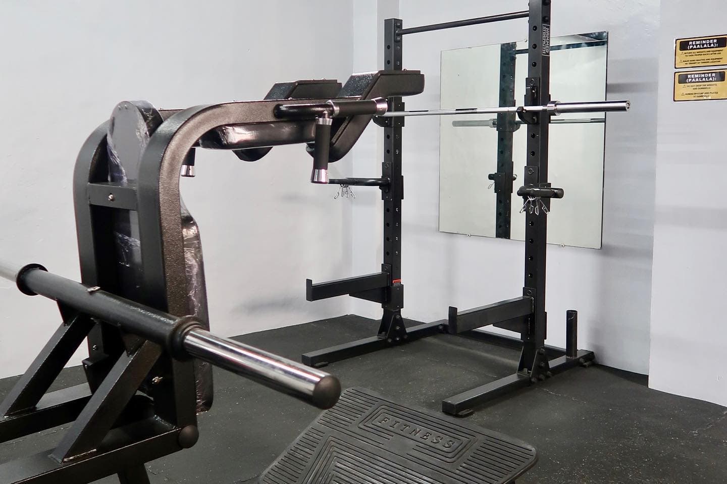 Squat rack with barbell at MNLA Fitness
